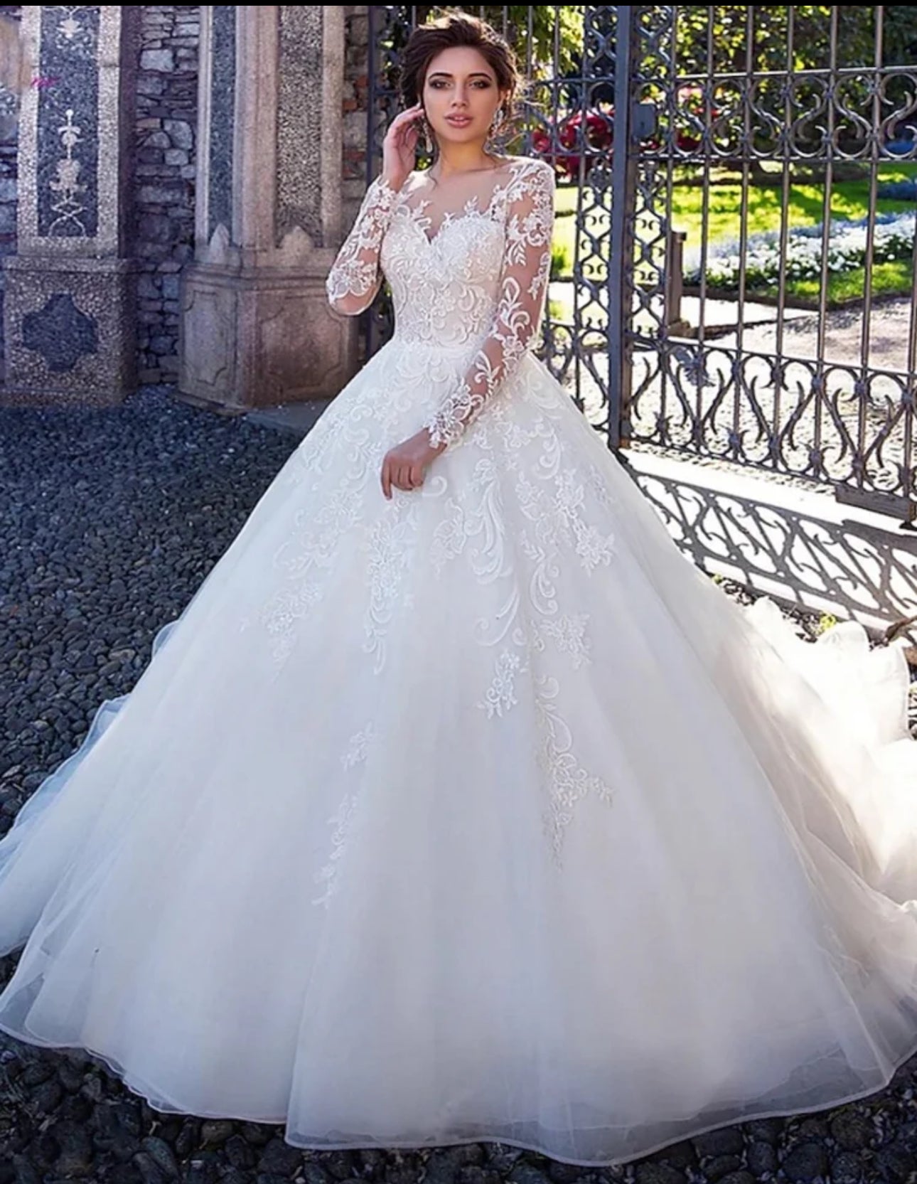 Experience Pure Elegance in our Long Sleeve Organza Bridal Ball Gown