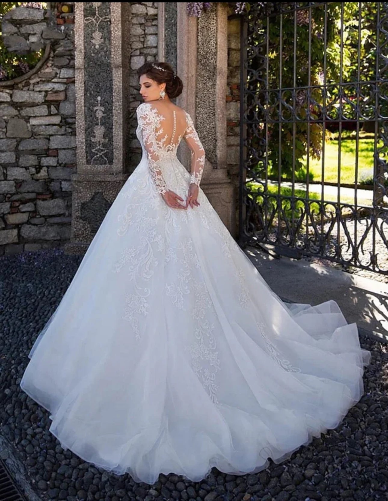 Experience Pure Elegance in our Long Sleeve Organza Bridal Ball Gown